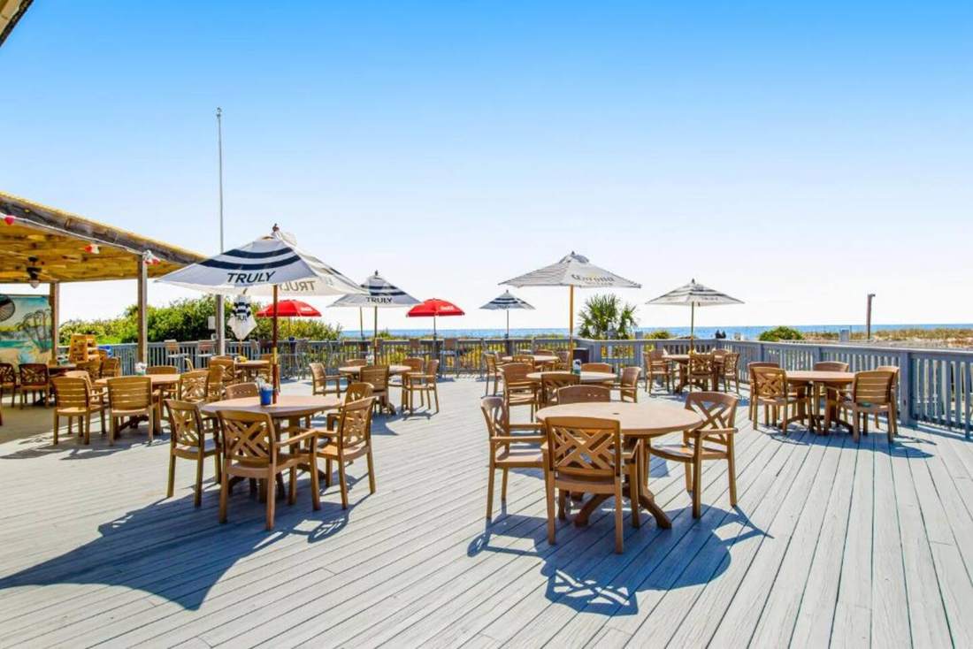 Jamaica Joe's deck with umbrellas by the pool and beach