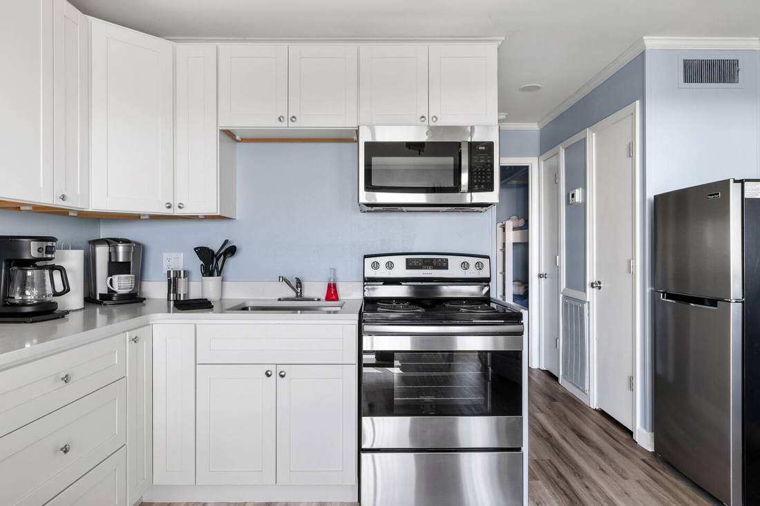 Kitchen with white cabinets and stainless steel appliances