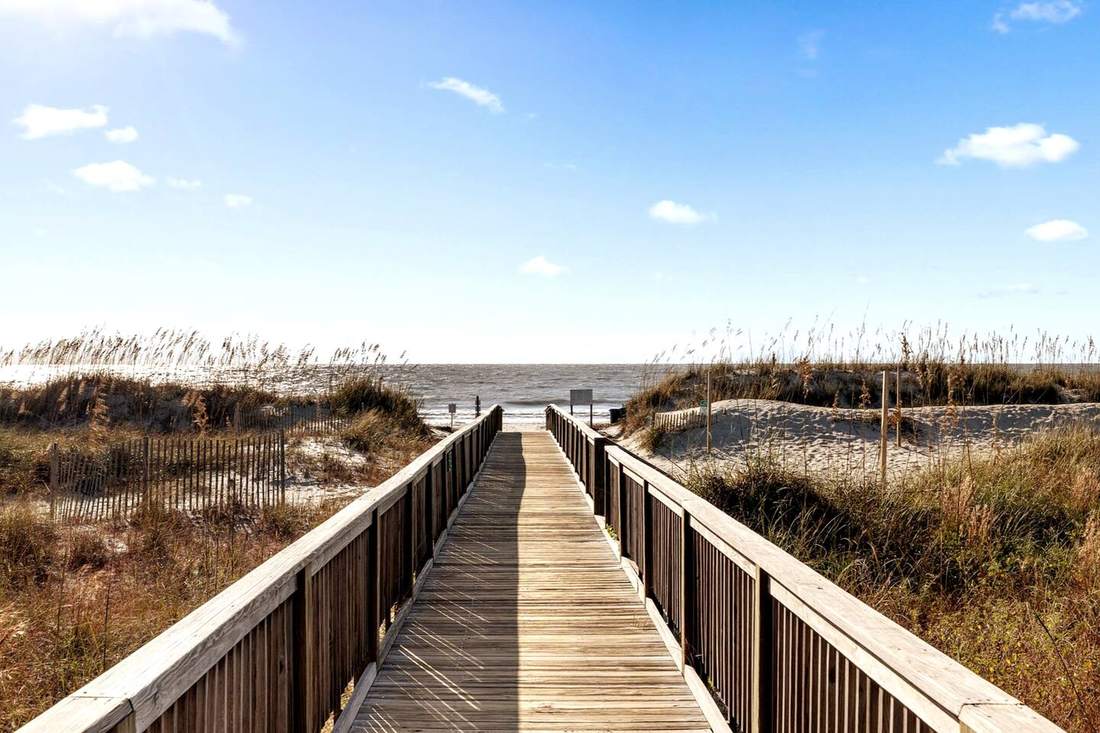Resort boardwalk through the dunes to the beach
