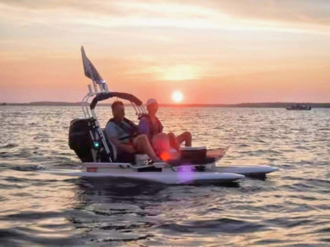 Small catamaran sailing at sunset off Hilton Head
